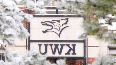 Snowy flower on campus in front of building